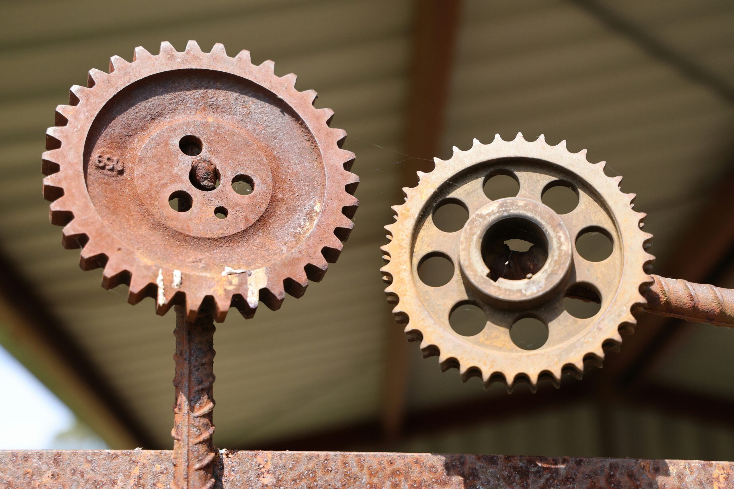 A close up of two gears on a piece of metal